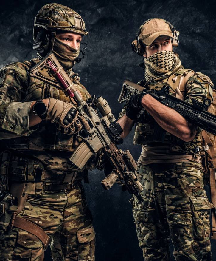 Two special forces soldiers in full protective equipment with assault rifles